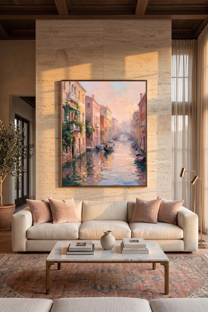 Textured Venice sunset impasto canvas art with a thin frame hung on a travertine stone wall behind a modern beige sofa.